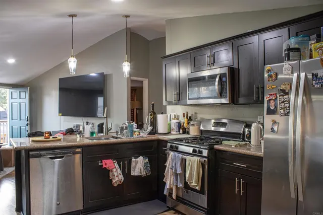 a kitchen with a sink stove and refrigerator