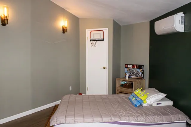 a view of a bedroom with a bed and toys