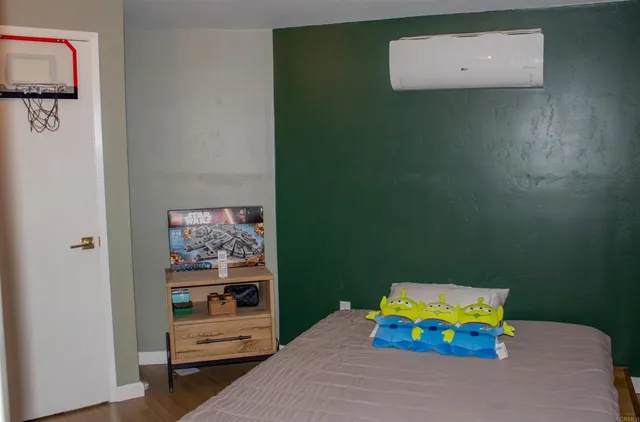 a bedroom with a bed and a wall painting