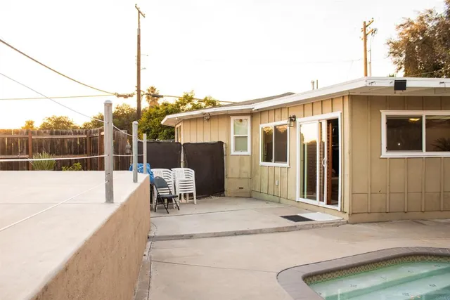 a backyard with wooden fence and some plants