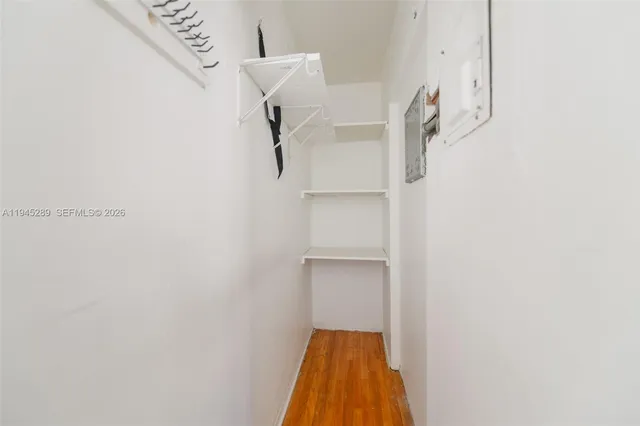 a view of walk in closet with racks on the wall