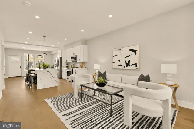 a living room with furniture and kitchen view