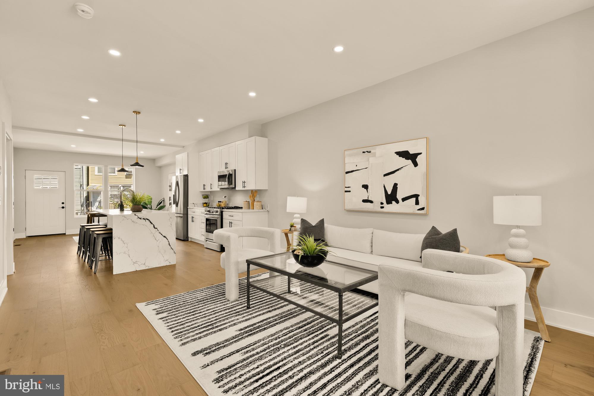 a living room with furniture and kitchen view