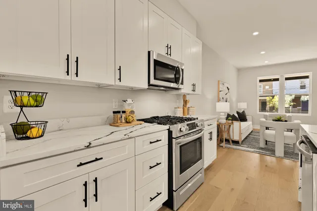 a kitchen with stainless steel appliances granite countertop a stove and a sink