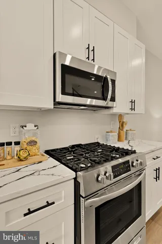 a kitchen with stainless steel appliances a stove and a microwave