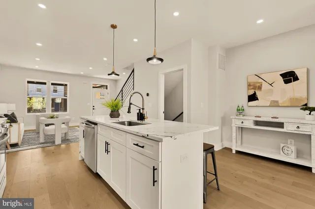 a kitchen with stainless steel appliances a stove sink and cabinets