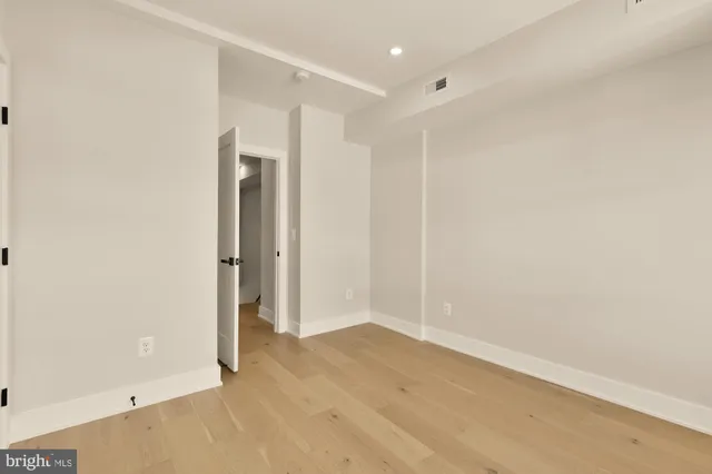 an empty room with closet area