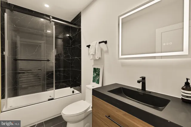 a bathroom with a toilet a sink and shower