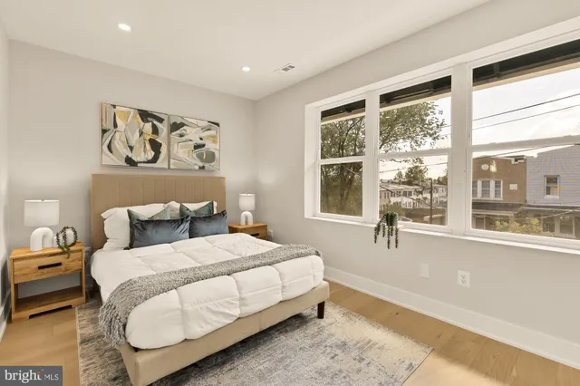 a bedroom with a bed and glass window