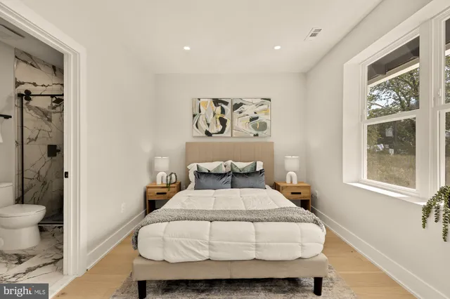 a bedroom with a large bed and a window