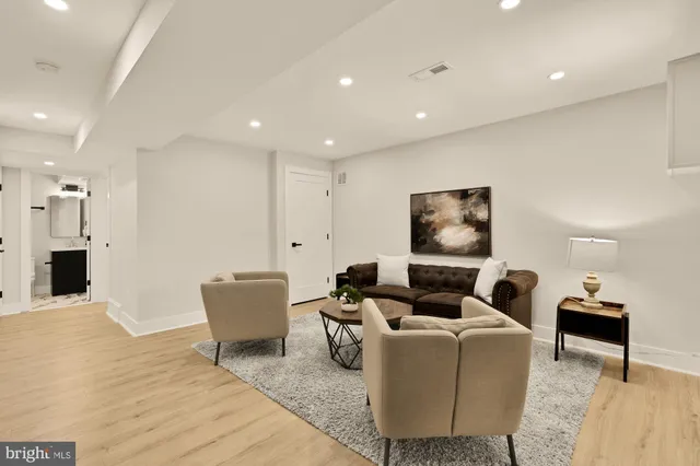 a living room with furniture and a wooden floor