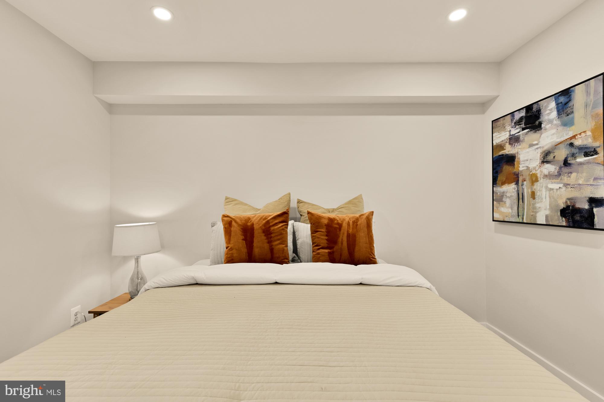 815 Marietta Place Northwest Washington, DC 20011 - Photo 40 of 44 a large bed sitting in a bedroom and a lamp