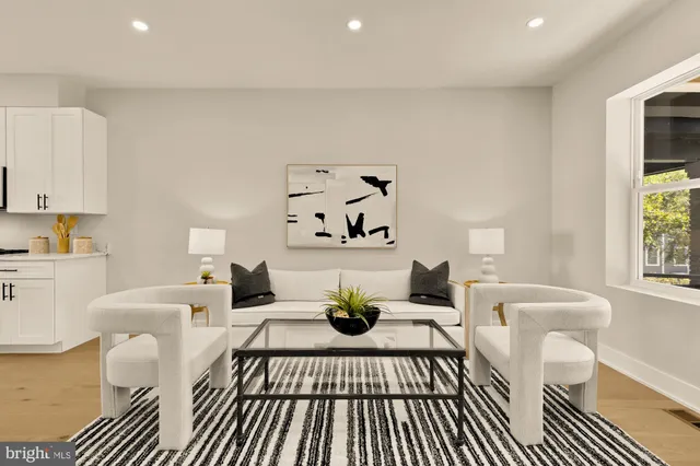 a living room with furniture a rug and a table