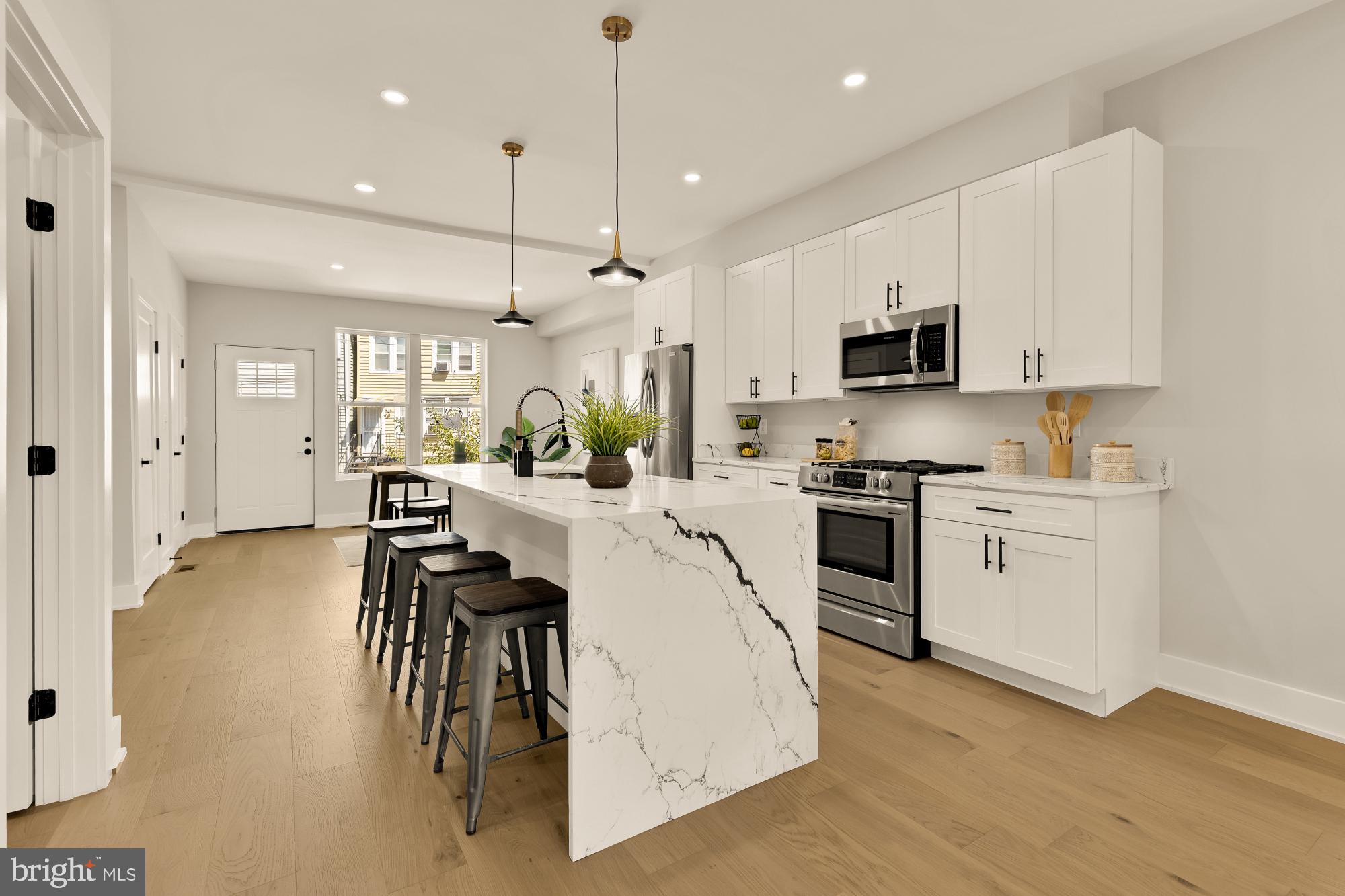 815 Marietta Place Northwest Washington, DC 20011 - Photo 7 of 44 a kitchen with white cabinets and stainless steel appliances