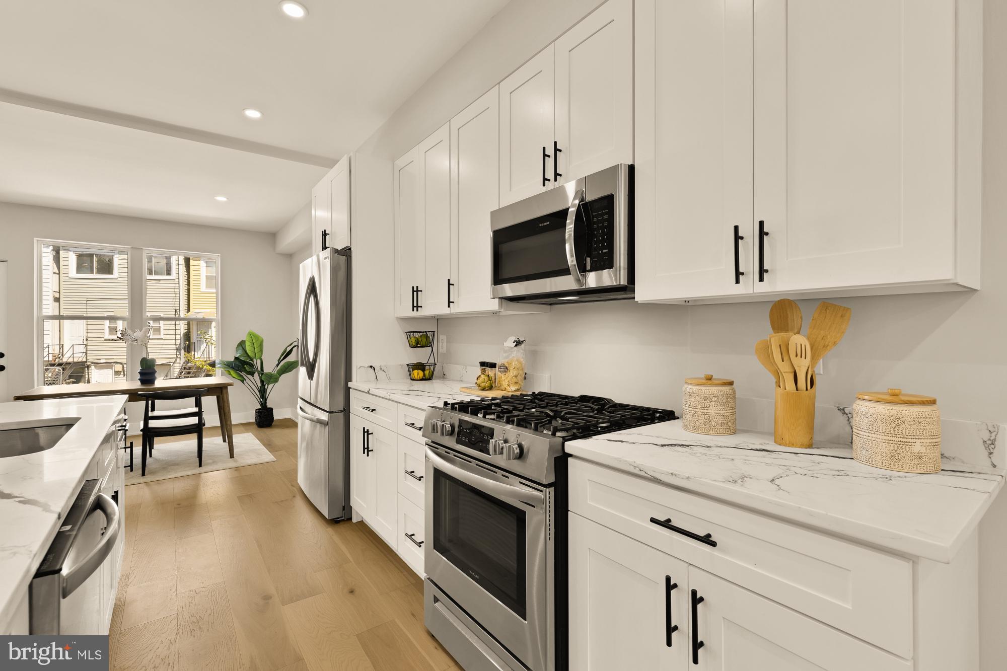 815 Marietta Place Northwest Washington, DC 20011 - Photo 10 of 44 a kitchen with stainless steel appliances granite countertop a stove a sink and a microwave
