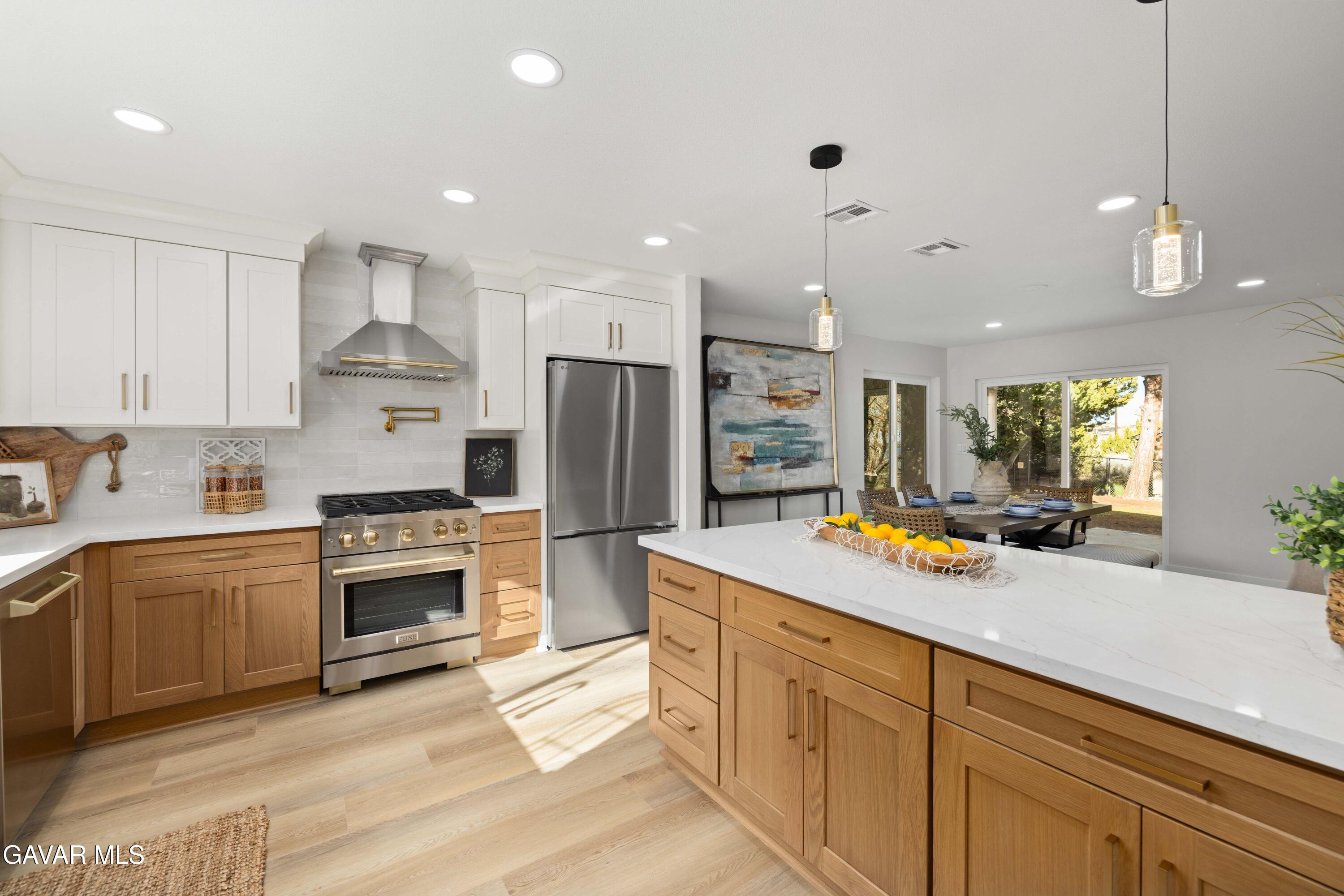 329 East Lago Lindo Road Palmdale, CA 93550 - Photo 11 of 39 a kitchen with white cabinets and stainless steel appliances