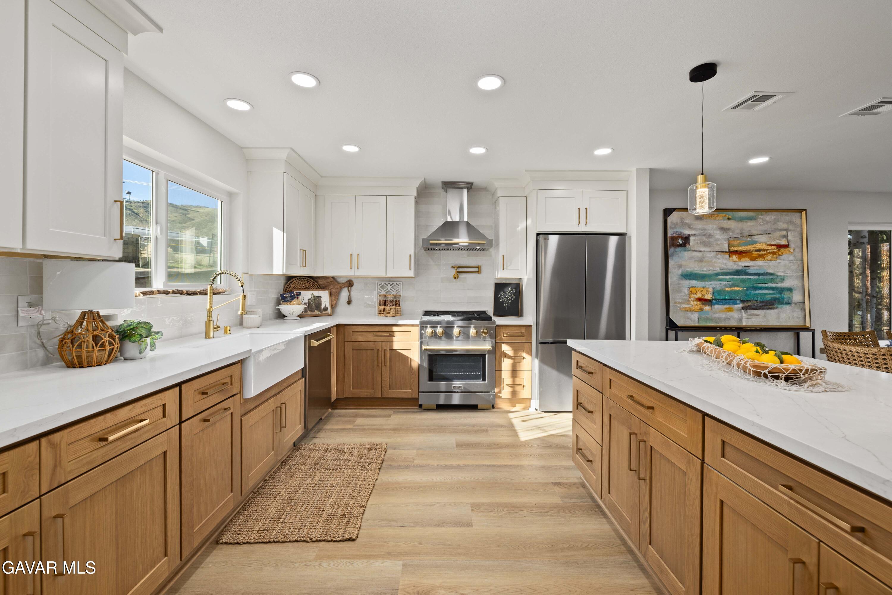329 East Lago Lindo Road Palmdale, CA 93550 - Photo 12 of 39 a kitchen with stainless steel appliances granite countertop a sink refrigerator and cabinets