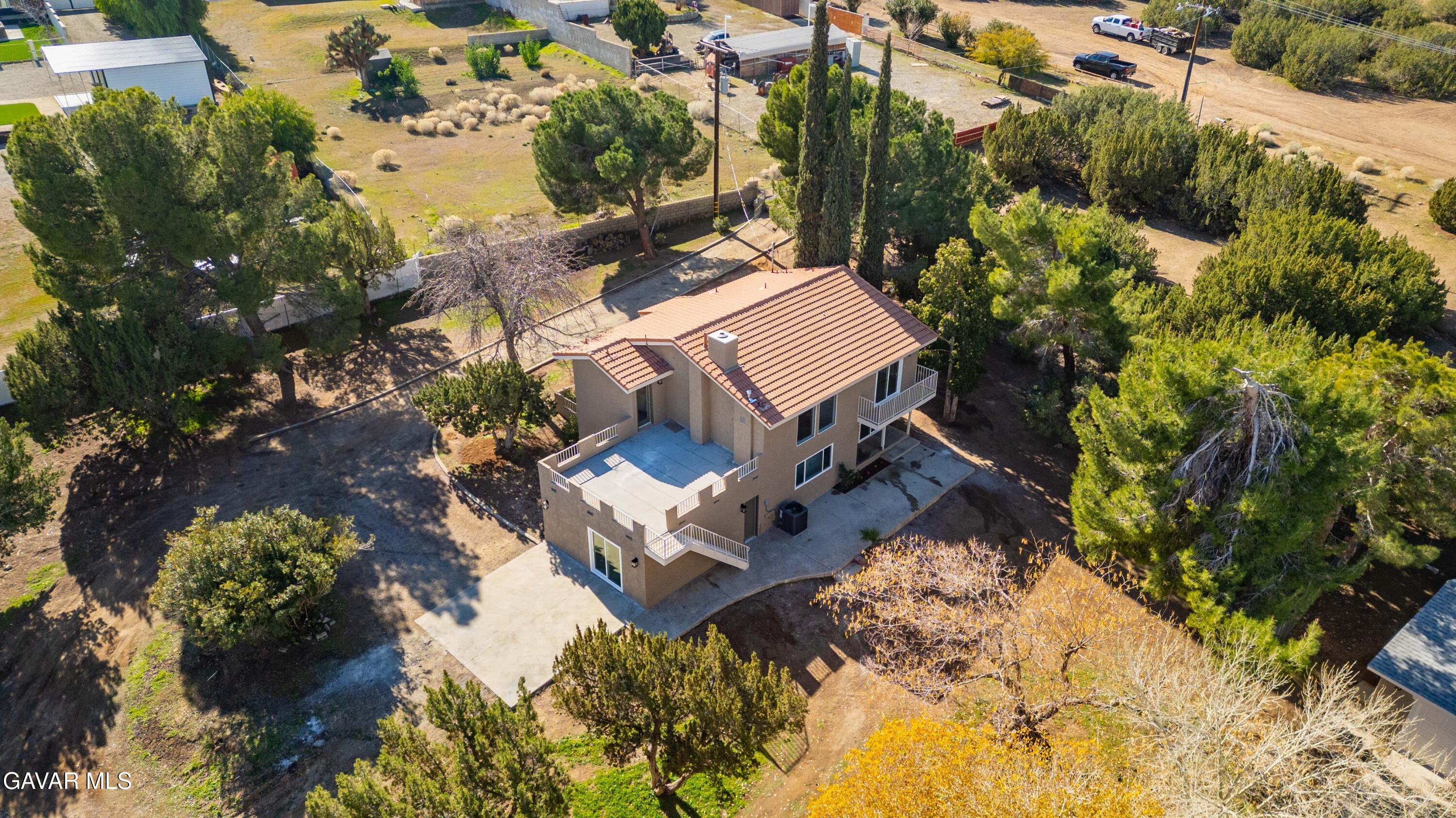 329 East Lago Lindo Road Palmdale, CA 93550 - Photo 19 of 39 a view of a house with a yard and garden