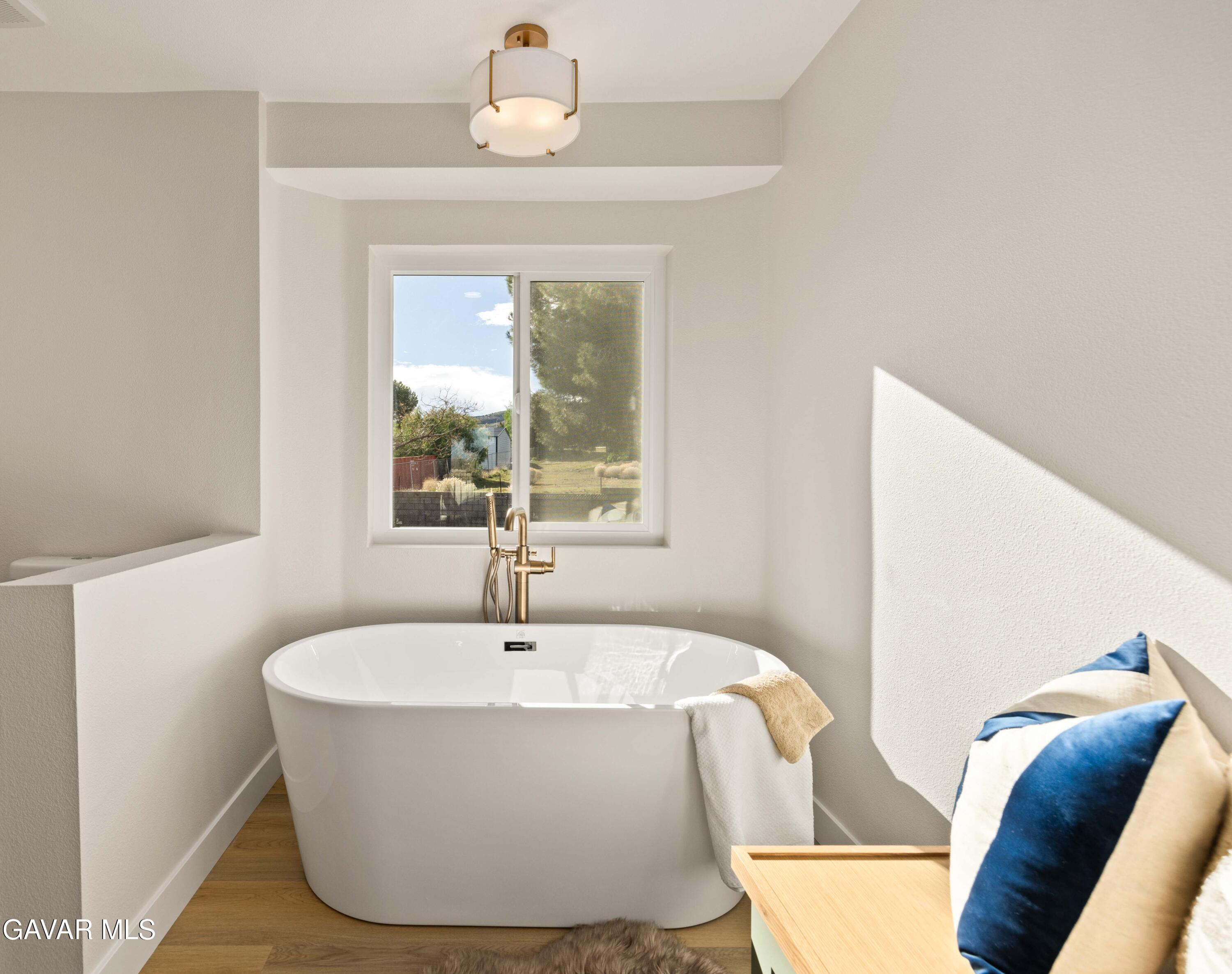 329 East Lago Lindo Road Palmdale, CA 93550 - Photo 20 of 39 a white bath tub sitting in a bathroom next to a window