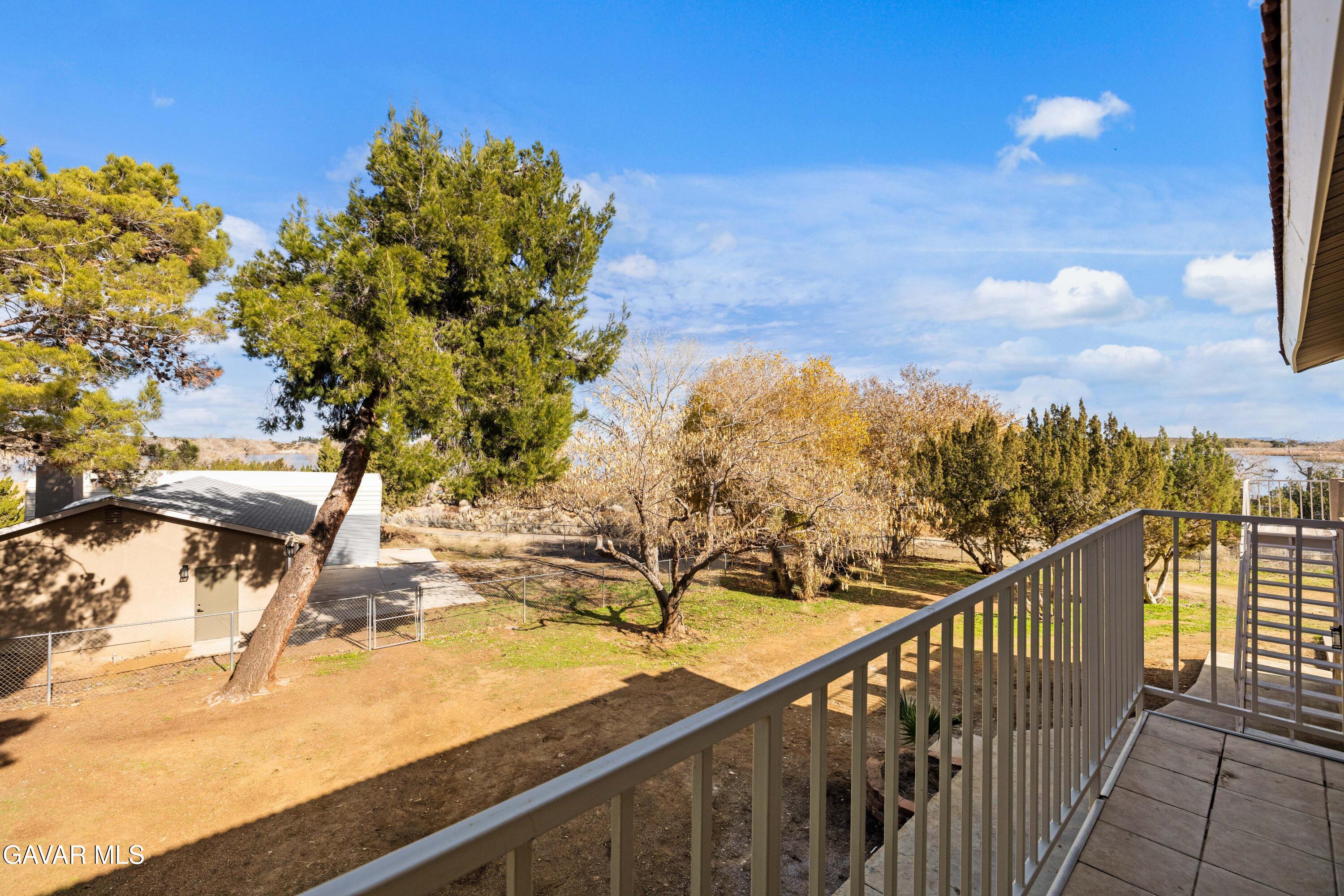 329 East Lago Lindo Road Palmdale, CA 93550 - Photo 24 of 39 a view of a balcony with two chairs