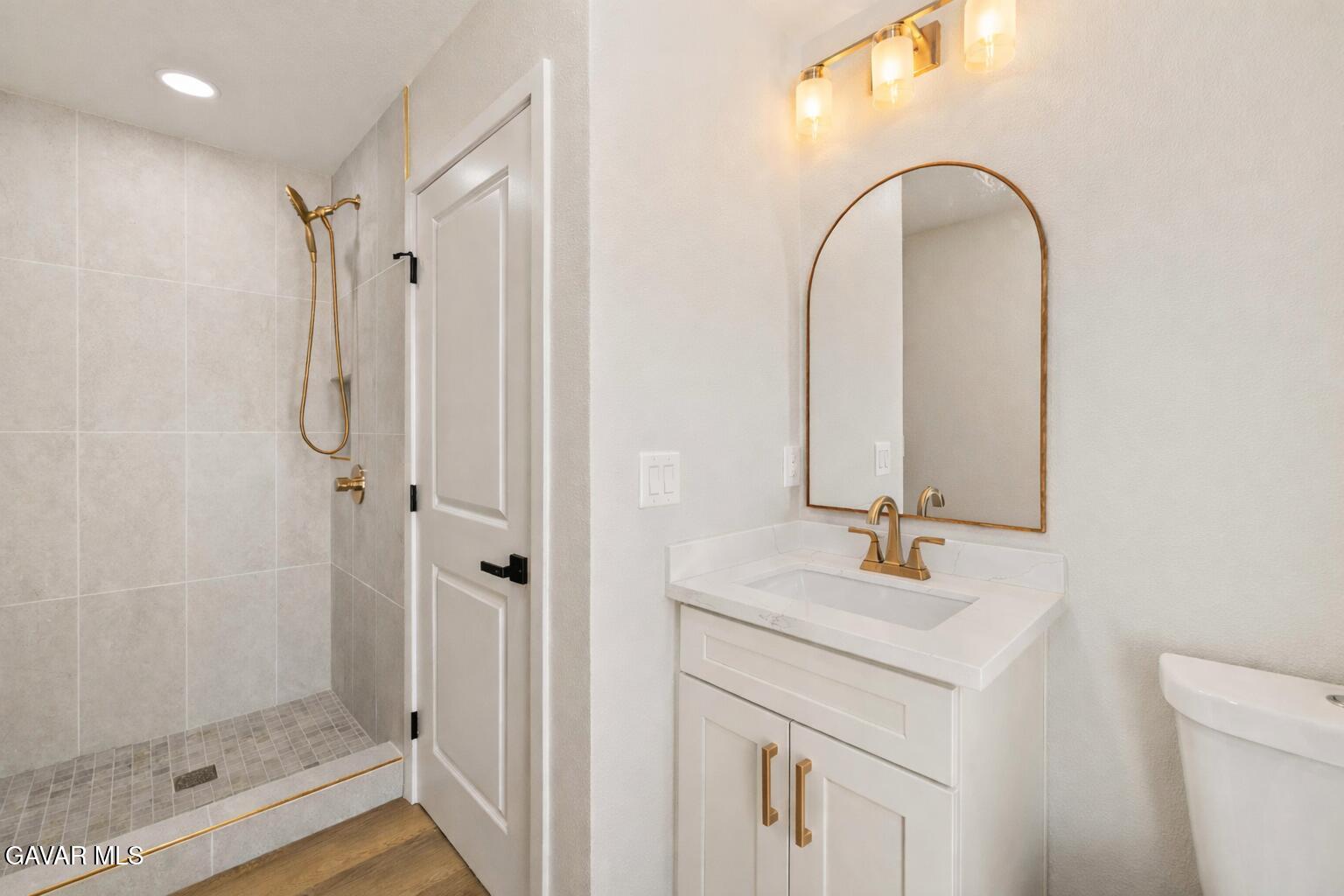 329 East Lago Lindo Road Palmdale, CA 93550 - Photo 30 of 39 a bathroom with a shower a sink and a mirror