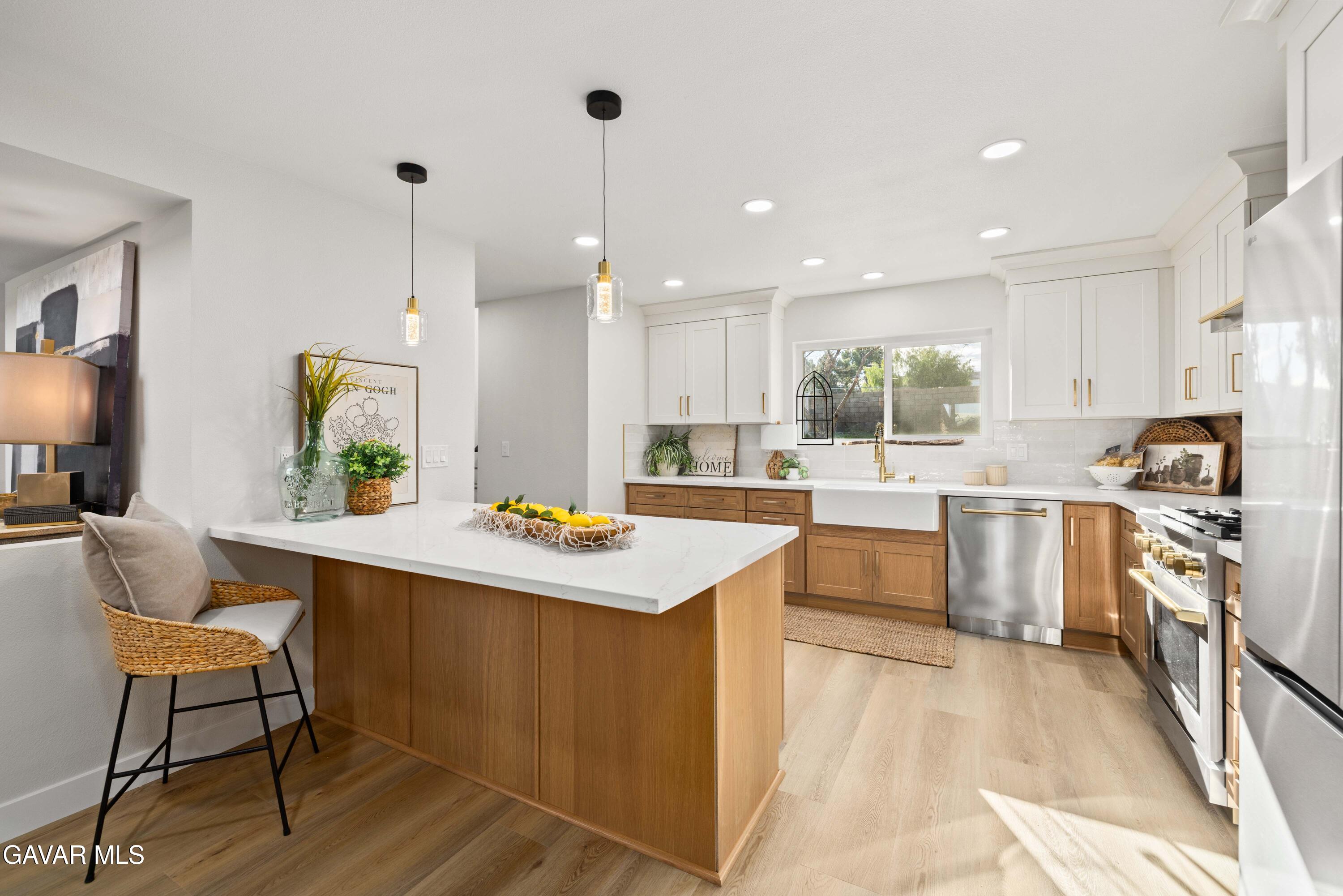 329 East Lago Lindo Road Palmdale, CA 93550 - Photo 3 of 39 a kitchen with a sink stove and wooden floor