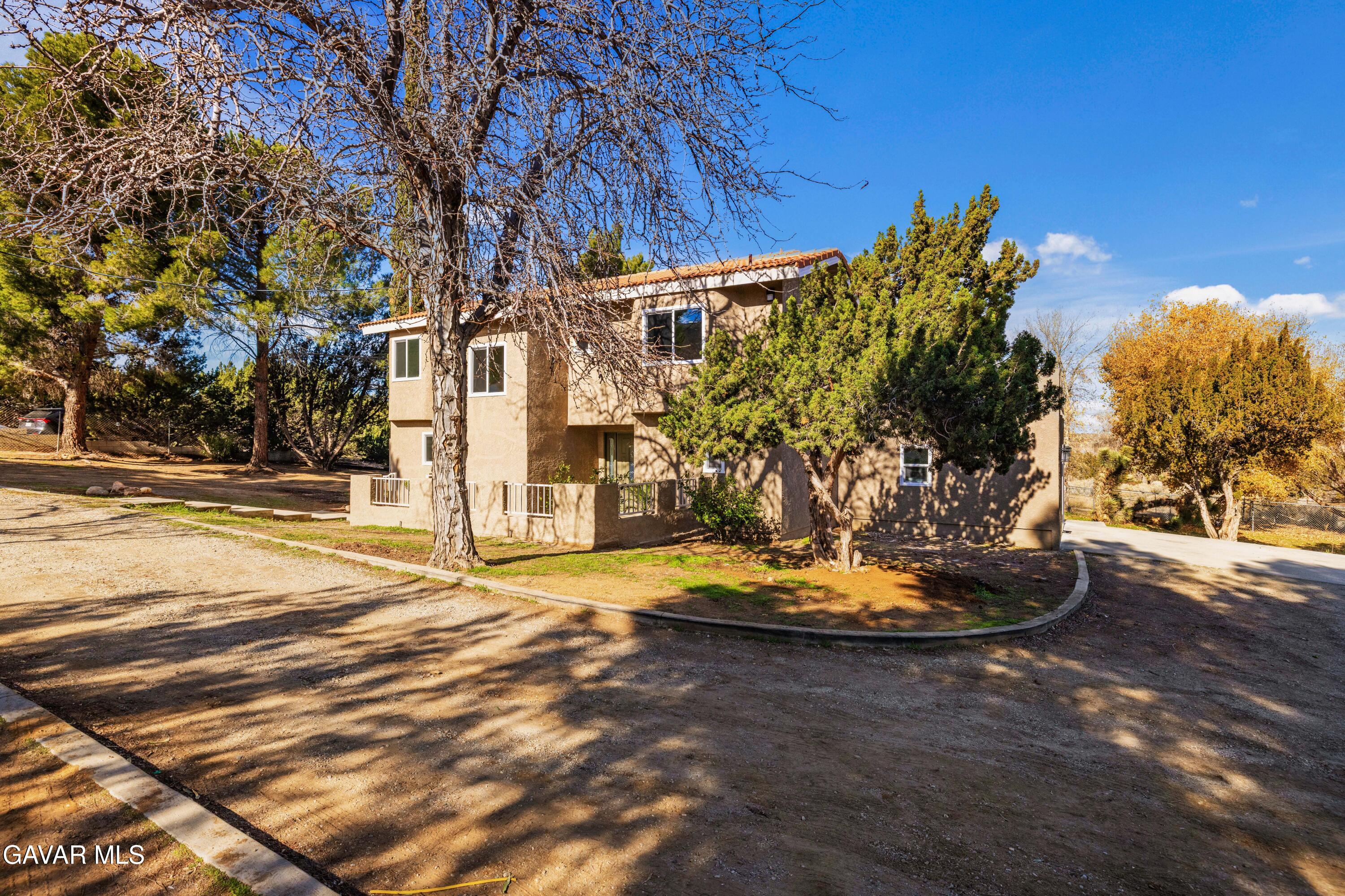 329 East Lago Lindo Road Palmdale, CA 93550 - Photo 33 of 39 a front view of a house with a yard