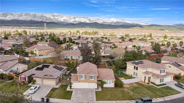 an aerial view of residential houses with outdoor space and ocean view