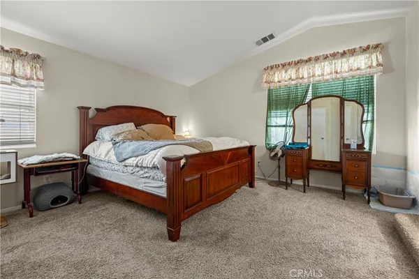 a bedroom with a bed and a mirror
