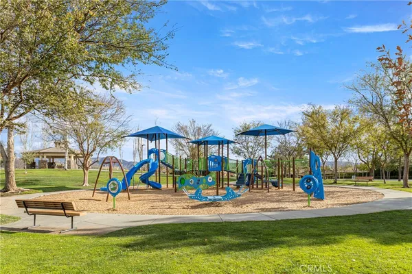 a view of a park with swings and slides