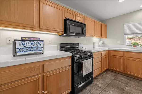 a kitchen with stainless steel appliances granite countertop a sink and a stove top oven