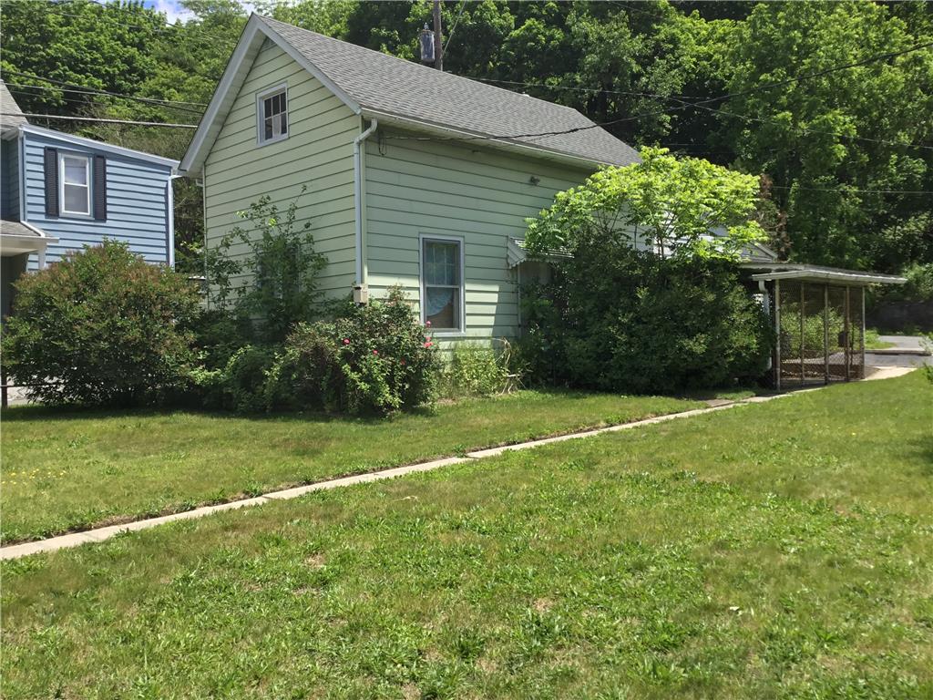 1105 Main Street Slatington, PA 18080 - Photo 30 of 31 A classic residential structure with light siding offers a comfortable, private retreat amidst natural landscaping.