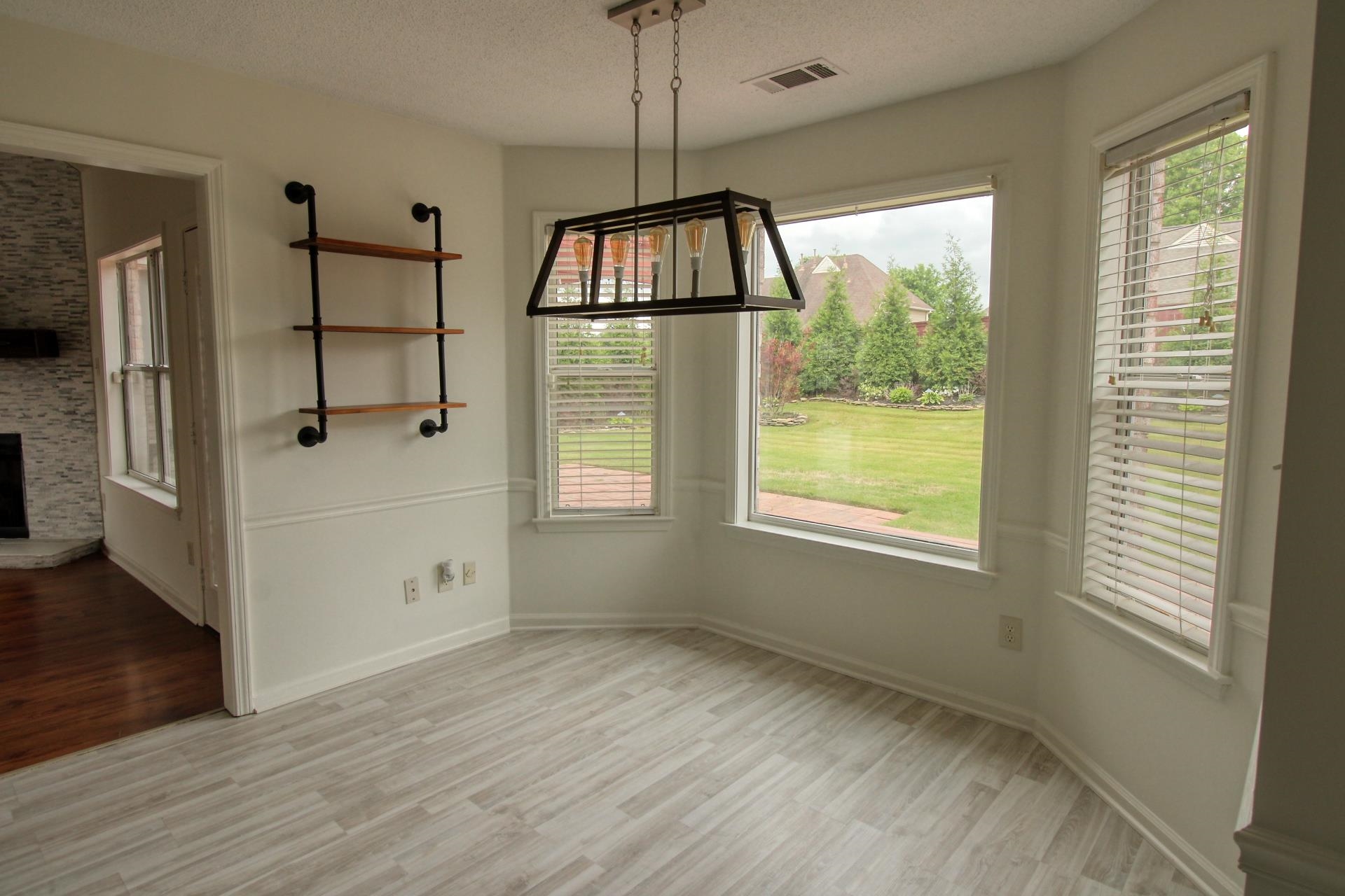 25 Whispering Ridge Cove Oakland, TN 38060 - Photo 7 of 20 Breakfast nook featuring light wood-finish flooring and a contemporary linear chandelier