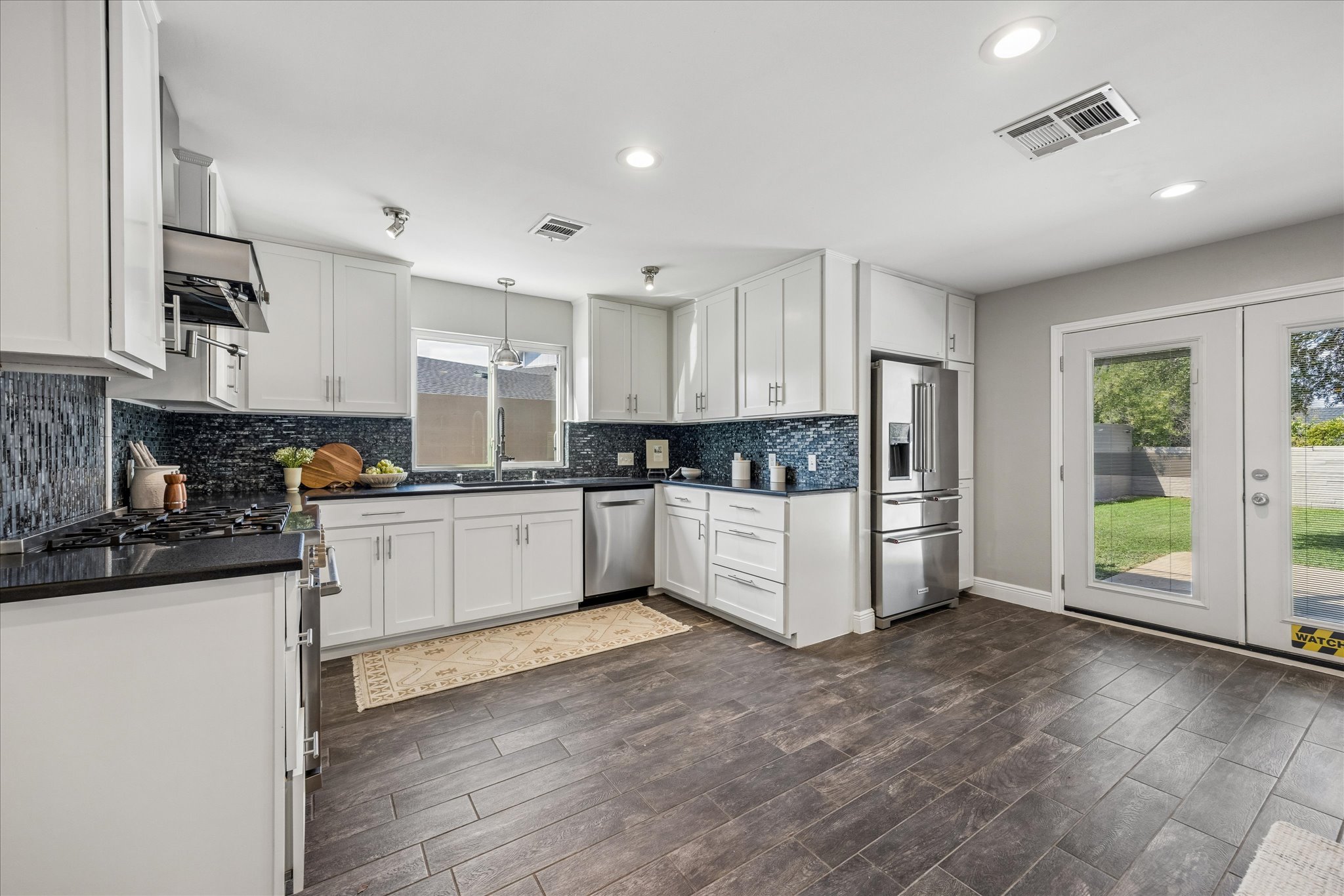 7905-7907 Tiffany Drive Austin, TX 78749 - Photo 10 of 36 Spacious kitchen with doors to the backyard (main house)