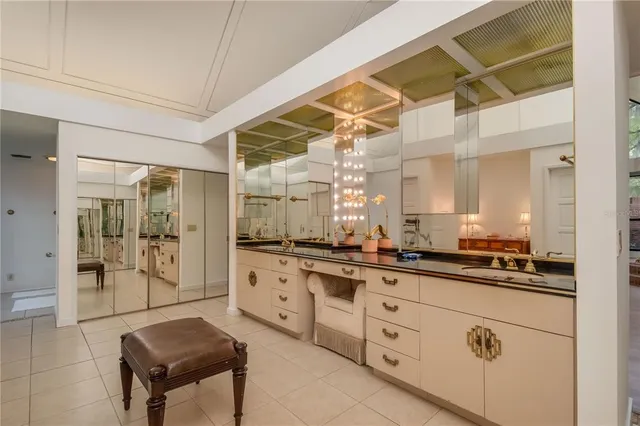 a kitchen with white cabinets and appliances