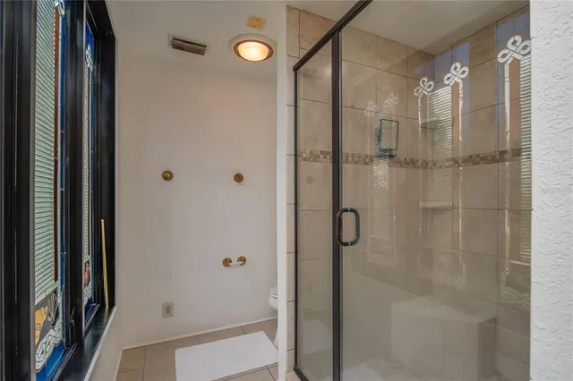 a bathroom with a glass shower door
