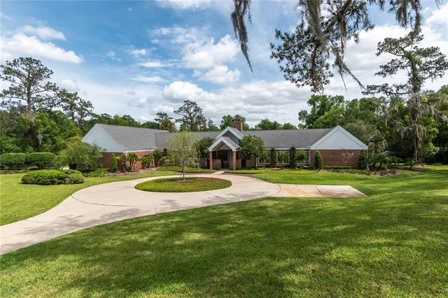a view of a house with pool and a yard