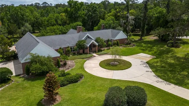 an aerial view of a house with garden space and street view