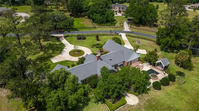 an aerial view of a house with swimming pool and outdoor space