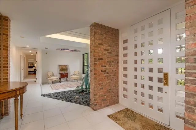 a living room with a rug and a shower