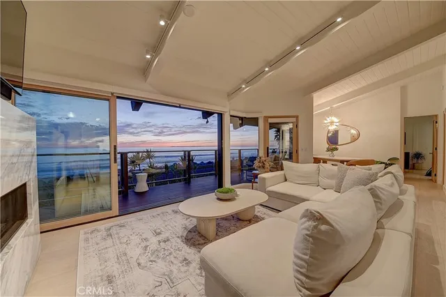a dining room with furniture a potted plant and a chandelier