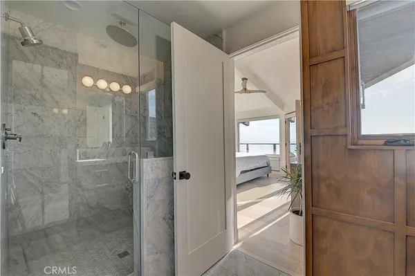 a bedroom with a large bed and a flat tv screen