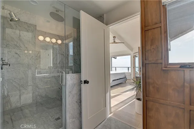 a bedroom with a large bed and a flat tv screen