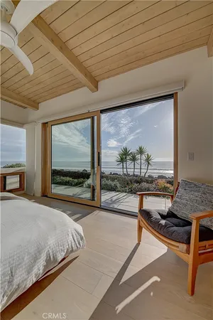 a spacious bedroom with a bed and a large window