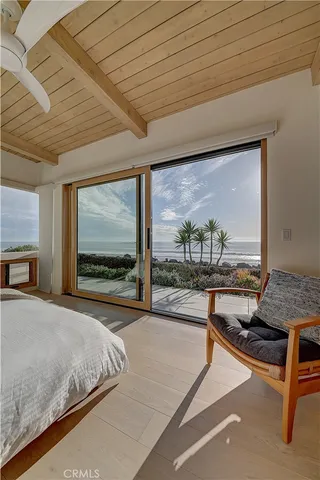 a spacious bedroom with a bed and a large window