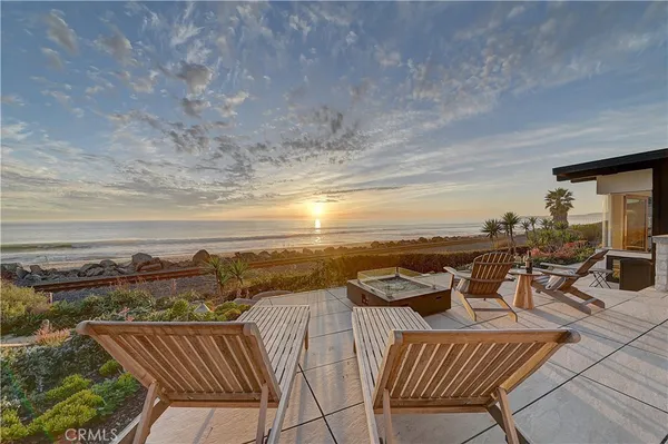 a view of a chairs and table in the balcony