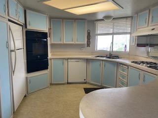 144 Holm Road, Unit 119 Watsonville, CA 95076 - Photo 13 of 29 a kitchen with stainless steel appliances granite countertop a sink stove and refrigerator