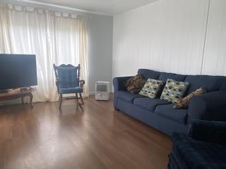 144 Holm Road, Unit 119 Watsonville, CA 95076 - Photo 15 of 29 a living room with furniture and a flat screen tv with wooden floor