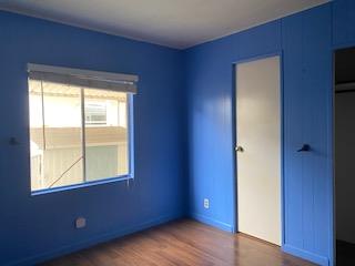 144 Holm Road, Unit 119 Watsonville, CA 95076 - Photo 20 of 29 a view of an empty room with wooden floor and a window