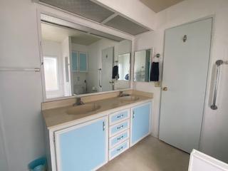 144 Holm Road, Unit 119 Watsonville, CA 95076 - Photo 24 of 29 a bathroom with a granite countertop sink and a mirror